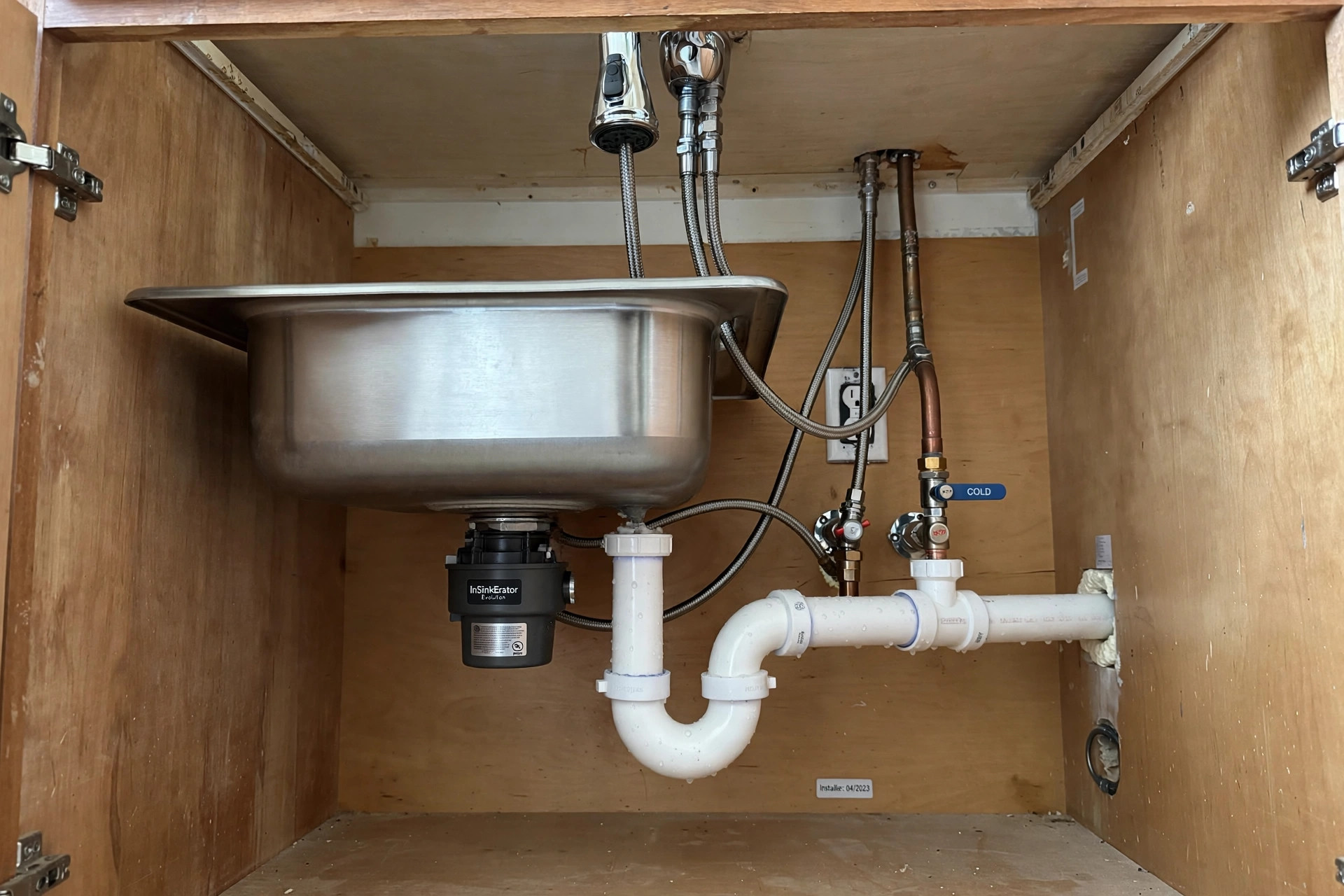 Kitchen sink with garbage disposal unit installed underneath